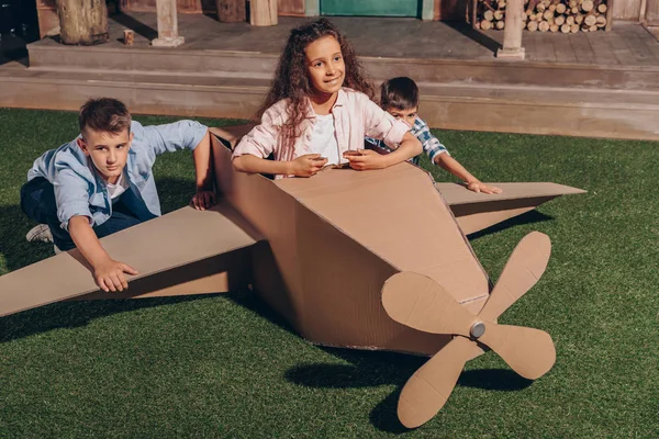 African american girl in cardboard airplane — Stock Photo