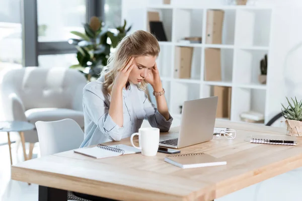 Tired businesswoman in office — Stock Photo
