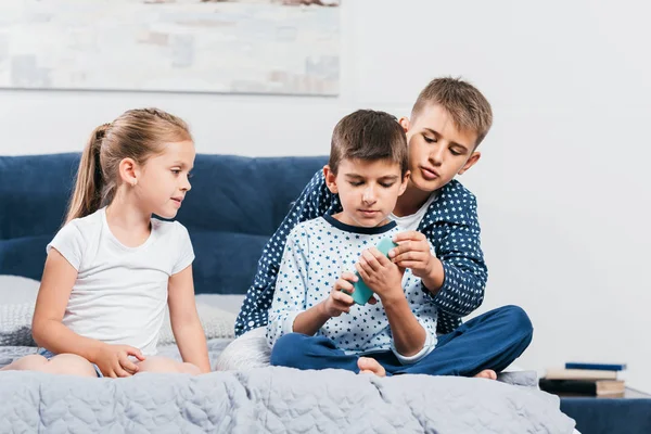 Діти зі смартфоном вдома — стокове фото