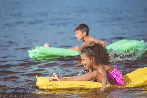 African american girl on inflatable mattress — Stock Photo