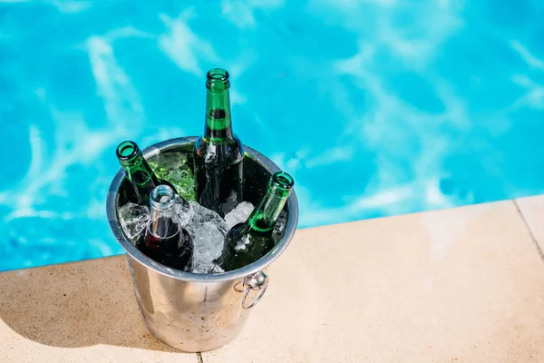 Bucket of cold beer near pool — Stock Photo