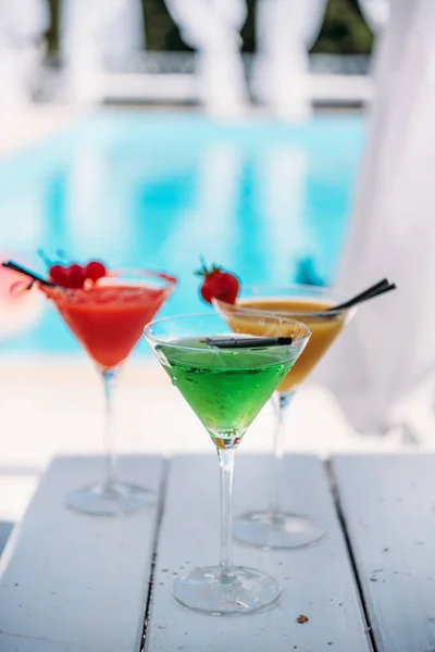 Colorful cocktails near pool — Stock Photo