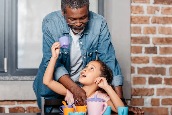 Girl having tea party with father — Stock Photo