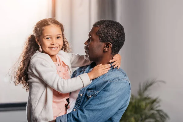 African american man holding daughter — Stock Photo