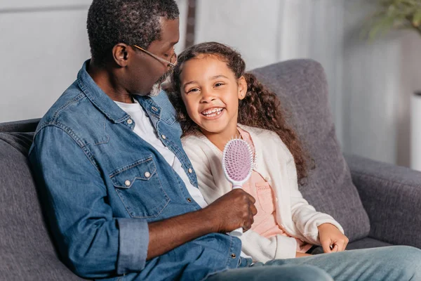 Africano americano hombre con hija en casa - foto de stock