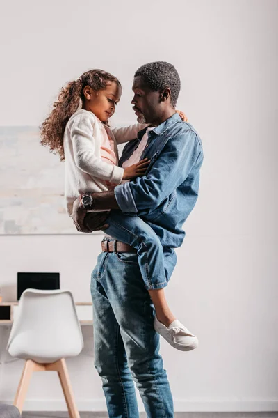 African american man holding daughter — Stock Photo