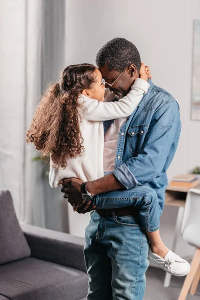 African american man holding daughter — Stock Photo