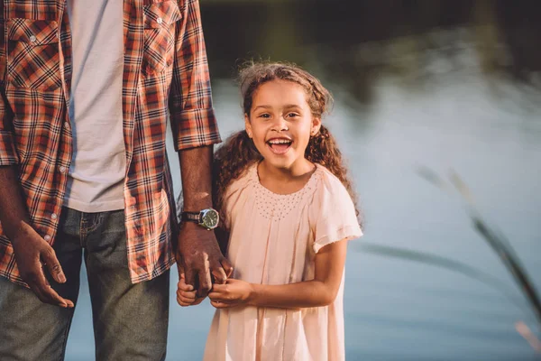 Granddaughter and grandfather holding hands — Stock Photo