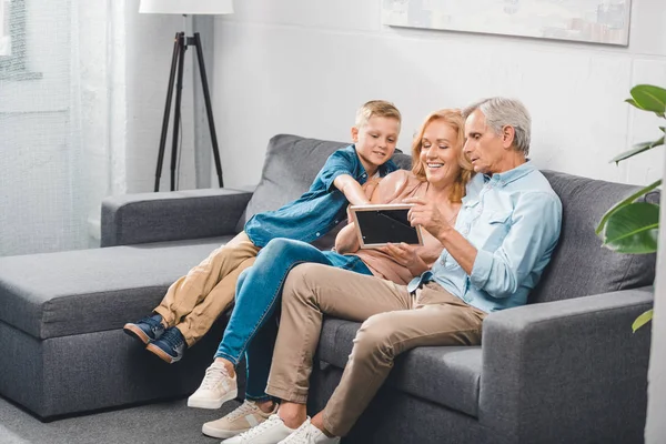 Family looking at photo frame — Stock Photo