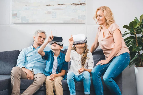 Grandchildren using virtual reality headsets — Stock Photo