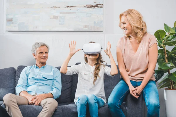 Granddaughter using virtual reality headset — Stock Photo