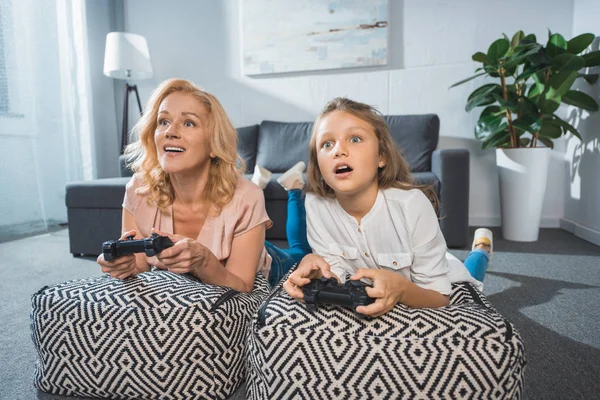 Grandmother and granddaughter with joysticks — Stock Photo