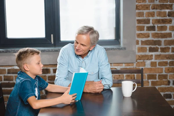 Grandfather and grandson reading book — Stock Photo