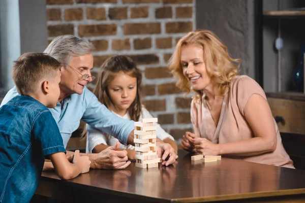 Family playing blocks wood game — Stock Photo