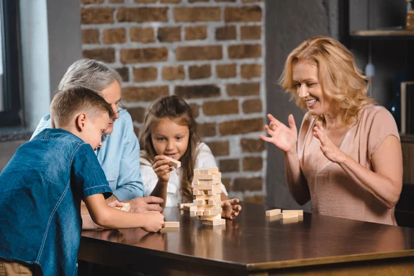 Family playing blocks wood game — Stock Photo