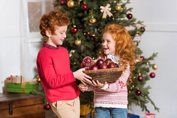 Siblings with christmas toys — Stock Photo