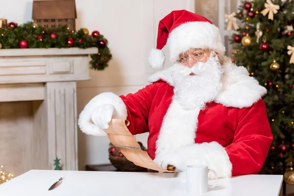 Santa claus reading wish list — Stock Photo