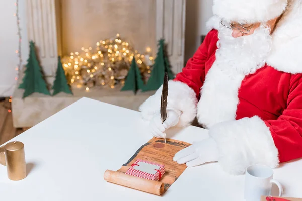 Santa claus signing wish list — Stock Photo