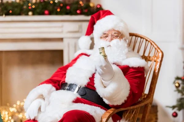 Santa claus with roll of money — Stock Photo