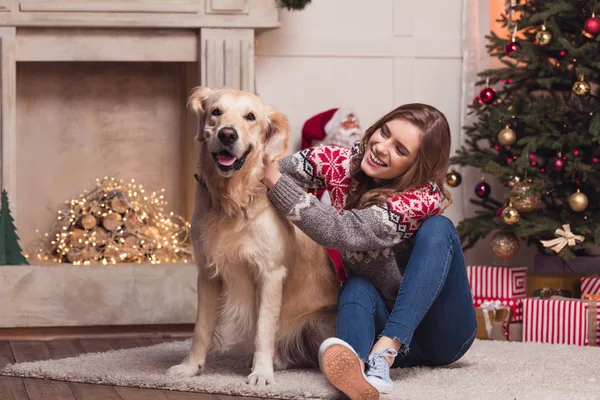 Young woman and dog at christmastime — Stock Photo