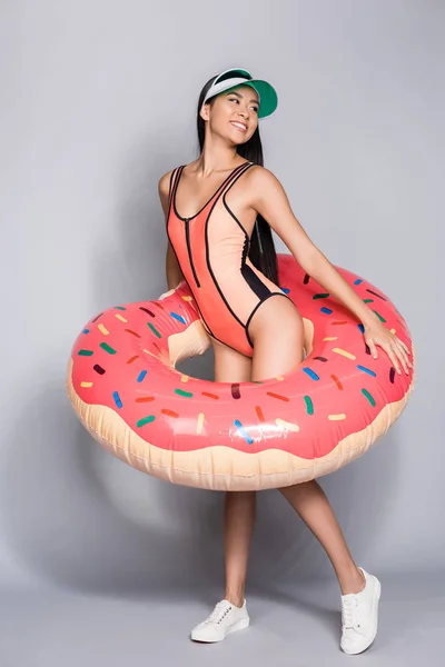 Woman in swimsuit wearing pool float — Stock Photo