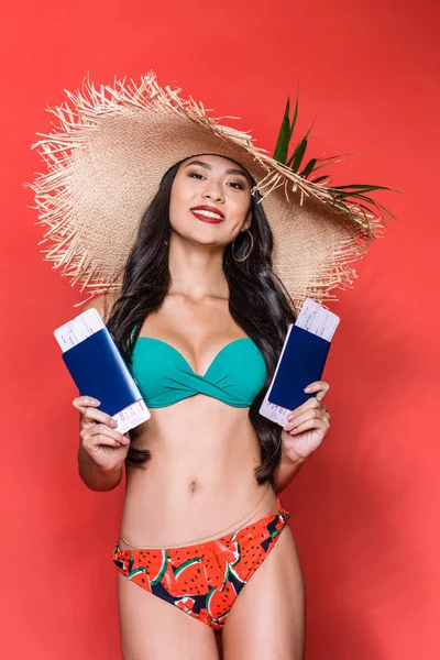 Woman in swimsuit holding tickets — Stock Photo