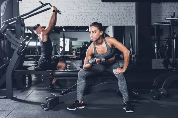 Athletic woman with barbell — Stock Photo