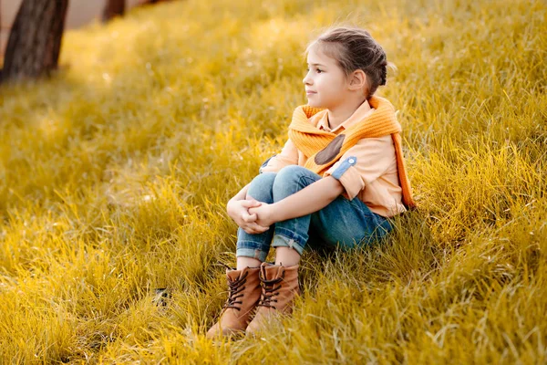 Child sitting in park — Stock Photo