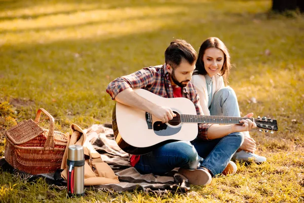 Junger Mann mit Freundin beim Gitarrespielen — Stockfoto