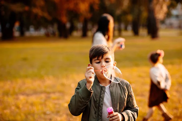 Boy blowing soap bubbles — Stock Photo