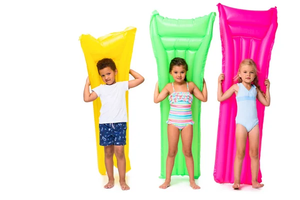 Multiethnic kids with swimming mattresses — Stock Photo