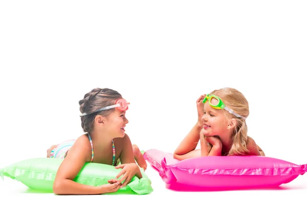 Happy kids on swimming mattresses — Stock Photo