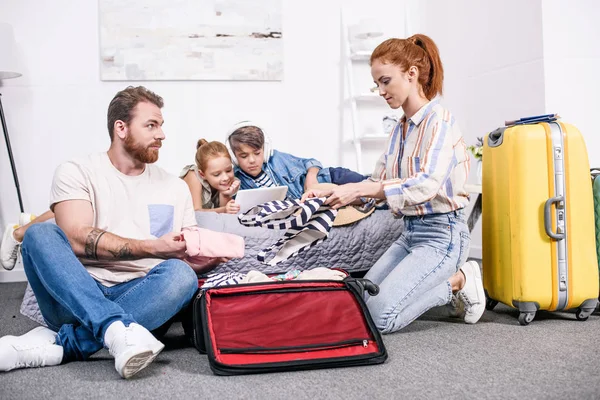 Family packing luggage for trip — Stock Photo