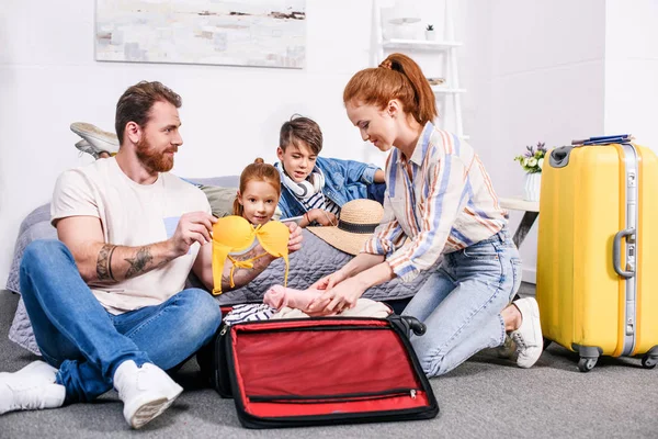 Family packing luggage for trip — Stock Photo