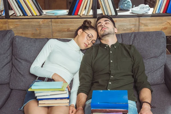 Sleeping couple with books — Stock Photo