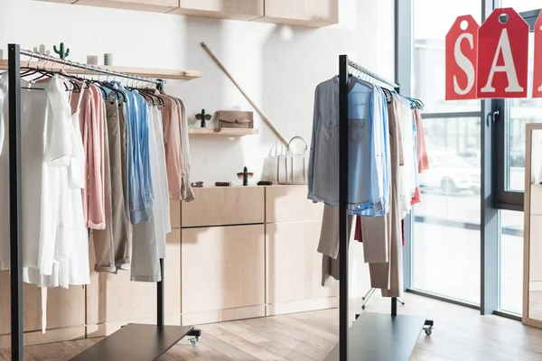 Racks with clothes in shop — Stock Photo