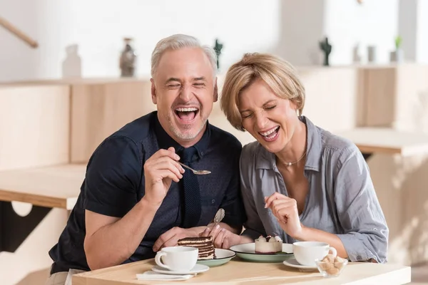 Couple manger des bonbons au café — Photo de stock