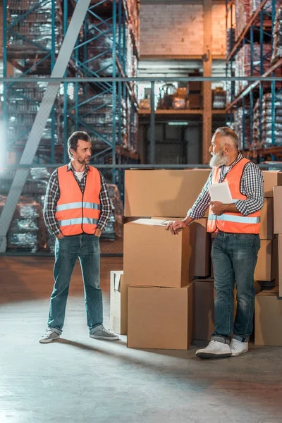 Warehouse workers with digital tablet — Stock Photo