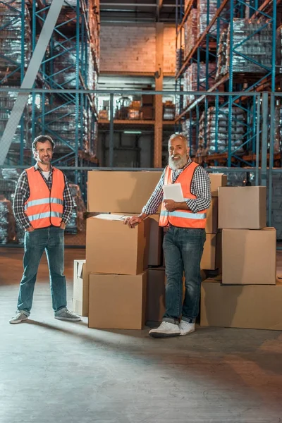 Warehouse workers with digital tablet — Stock Photo