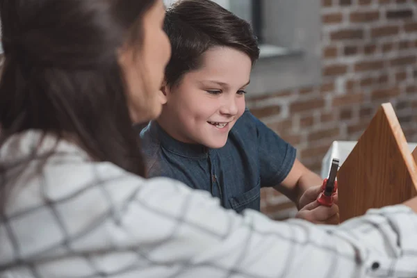 Boy building birdhouse — Stock Photo