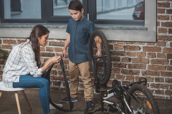 Family fixing bicycle — Stock Photo