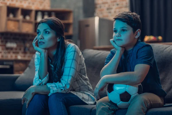 Bored family watching soccer — Stock Photo