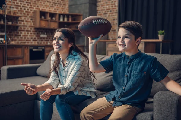 Cheering family watching american football — Stock Photo