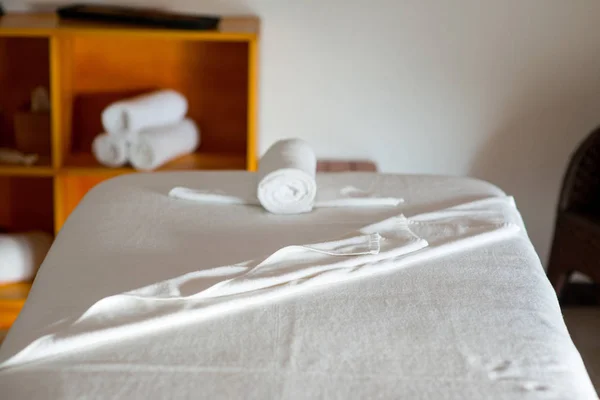 Rolled towel on massage table — Stock Photo