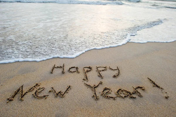 Happy new year sign on beach — Stock Photo