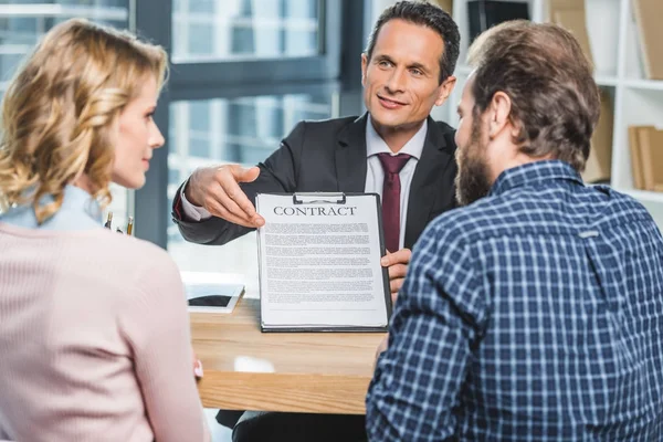 Lawyer showing contract to clients — Stock Photo