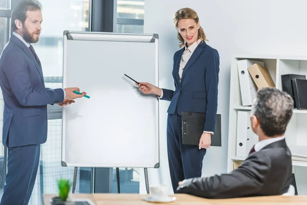 Lawyers pointing at white board — Stock Photo