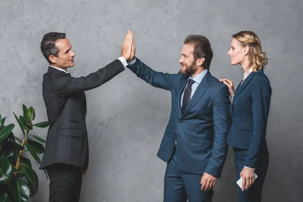 Businesspeople giving high five — Stock Photo