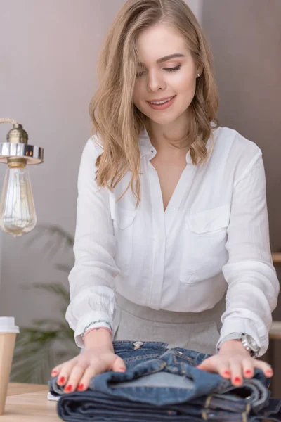 Portrait of beautiful entrepreneur packing products for customers in cardboard boxes at home office — Stock Photo