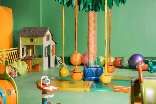 Swings and colorful toys in entertainment center — Stock Photo
